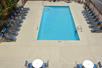 Outdoor pool with sun loungers at Red Roof Inn PLUS+ San Antonio Downtown, Riverwalk.