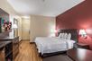 One King bed, flat TV and a working area inside a guest room at Red Roof Inn PLUS+ San Antonio Downtown, Riverwalk.
