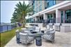 Relaxing outdoor patio with a seating area, fire pit, and barbecue grill.