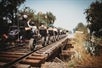 A group of people on rail bikes heading down the railway in West Sacramento, California.