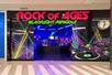 The entrance to Rock of Ages Blacklight Mini Golf with lasers painted onto their windows at the Mall of America.