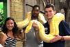 Guests hold a large yellow boa snake at the Aquarium