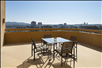 Private balcony with a table and four chairs.