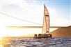 The Adventure Cat sailing catamaran at sunset with the Golden Gate Bridge