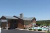 Exterior view of Scenic Hills Inn and their pool on a sunny day with a clear sky in Branson, Missouri, USA.