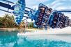 The Manta coster full of people splashing into the water on a sunny day at SeaWorld in Orlando, Florida.