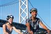 Couple biking near the Bay Bridge on the Self-Guided Bike Tour in San Francisco