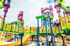 A large water park playground with several levels and slides on a sunny day at Sesame Place in San Diego, California.