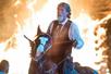 Jim Lane riding a horse with a fire behind him at Shepherd of the Hills Outdoor Drama in Branson, Missouri.