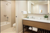 Relax in the bath and shower combination, with fresh towels and a well-appointed sink for your comfort.