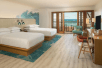 Guest room with two queen beds, flat-screen TV, and private lanai with ocean view.