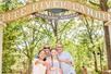 A family taking a selfie in front of the sign for White River Landing in Branson, Missouri.