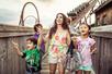 A family with small children walking with the Wild Fire roller coaster behind them at Silver Dollar City in Branson, Missouri.