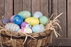 Easter basket full of colorful hand painted eggs