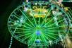 Aerial view looking down on the Myrtle Beach SkyWheel at night glowing a toxic green color.