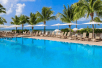 Outdoor pool with sun loungers and beach umbrellas at Southernmost Beach Resort in Key West FL.