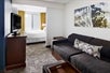 Seating area with flat-screen TV and sofa bed area inside a guest suite at SpringHill Suites Richmond North / Glen Allen.