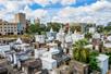 Aerial view over looking St. Louis Cemetery No. 1 on a sunny day with the city of New Orleans in the background.