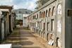 Rows of tombs stacked on top of each other on both sides of a walk way at St. Louis Cemetery No. 1.