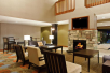 Lobby with seating area, fireplace, and flat-screen TV.