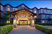 Beautifully landscaped hotel exterior at dusk.