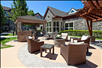 Outdoor patio with seating area and fire pit.