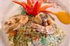 Experience a burst of flavors with this beautifully presented dish, featuring fresh shrimp and a vibrant red pepper on the Boozy Brunch food tour in St. Augustine.