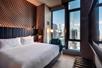 Guest room with one king bed, seating area, and an overlooking city view.