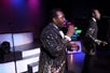 Close up of two men in gold suits singing into microphones on stage at The Best of Motown and More in Branson, Missouri.