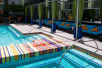 Oasis pool with colorful tile separating pool from hot tub.