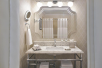 A well-lit vanity area inside a private bathroom.