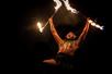 A man Fire Dancing and yelling at night at The Feast at Mokapu Luau in Wailea, Hawaii, USA.