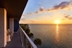 View of the bay at sunset from a guest room balcony at The Godfrey Hotel & Cabanas in Tampa, Florida. 
