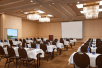 Spacious meeting facility with chairs, tables, and whiteboard.