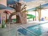 Indoor pool area with a waterslide.
