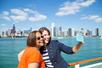 Two ladies posing for a selfie with Chicago in the background on the Urban Adventure Cruise in Chicago, Illinois, USA.