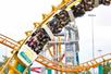 A roller coaster car full of people going upside down on the Corkscrew coster at Valleyfair in Bloomington, Minnesota.