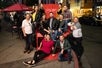 A group photo taken on a red wooden chair in Little Italy