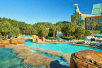 Grotto pool with tropical waterfalls and a water slide at Walt Disney World Swan.