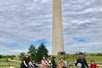 A group of families taking photos at the Washington Monuments