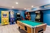 Games room with pool table and arcade games.