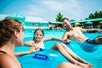 A family floating in the wave pool in tubes on a sunny day at White Water in Branson, Missouri.