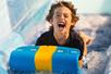A young boy screaming while going down a water slide at White Water in Branson, Missouri.