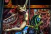 A woman in lingerie pole dancing on a zombie carrousel horse on stage at Zombie Burlesque in Las Vegas.