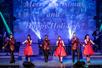 Three women in red dresses and three men in red and black suit jackets performing during the Christmas show at #1 Hits of the 60's.