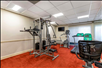 Fitness center with treadmill, elliptical trainer, and other gym equipment.