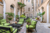 Courtyard with tables and chairs at voco St James Hotel, an IHG hotel, LA.