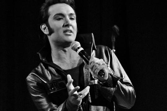 A black and white photo of an Elvis impersonator at A Salute to Elvis in Pigeon Forge, Tennessee.