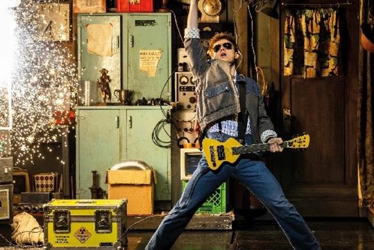 Marty McFly playing the guitar with sparks flying in Back to the Future: The Musical on Broadway in New York.