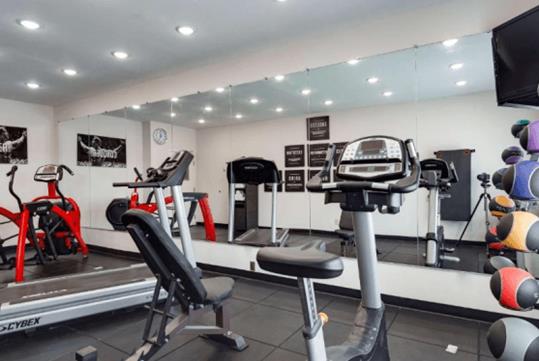 24-hour fitness room with treadmill, and other cardio equipment.